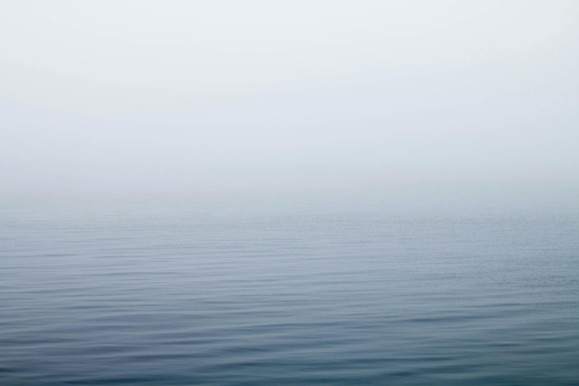 body of water under fog
